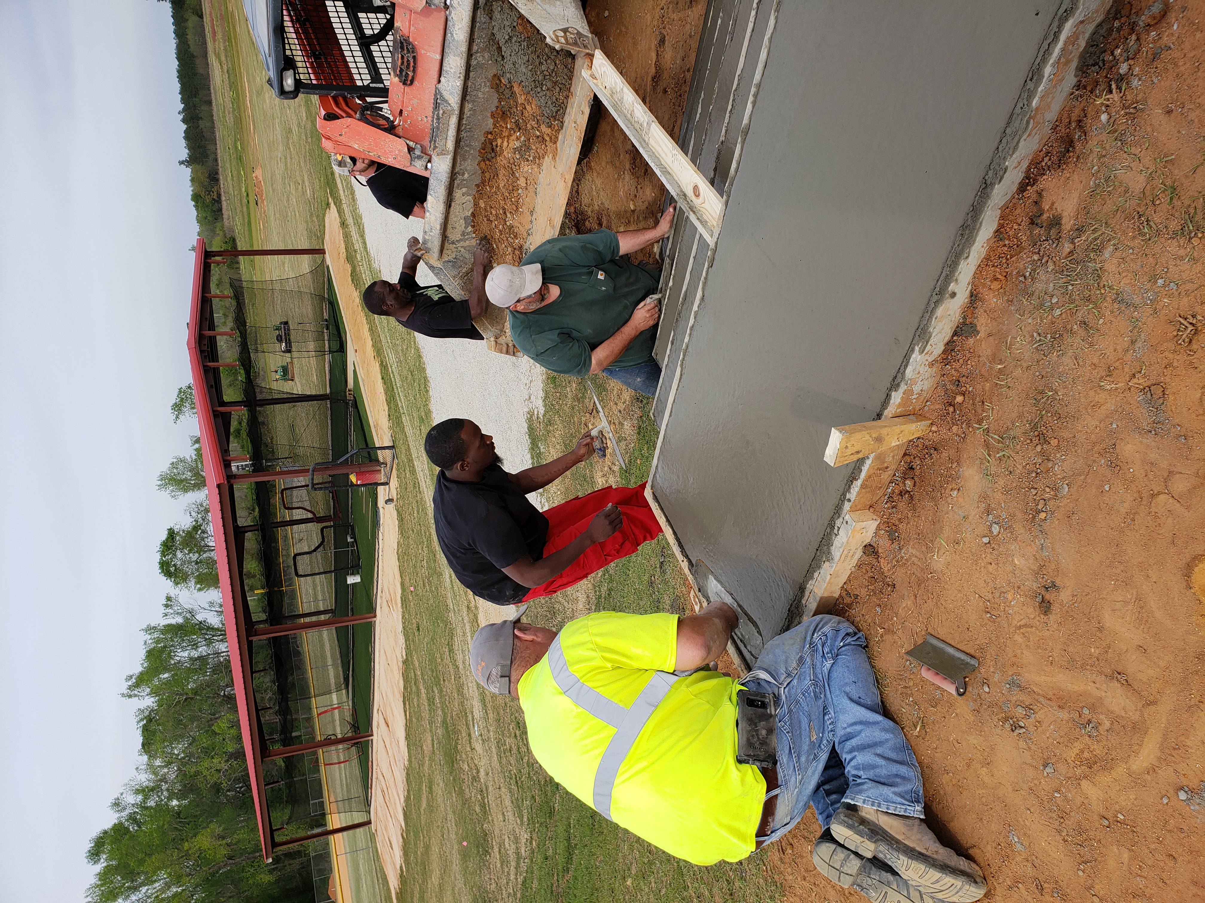 Crew finishing a freshly poured concrete slab